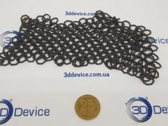 3D-printed chainmail sample with a coin for scale by 3DDevice.