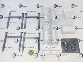 A collection of 3D-printed parts for a detailed layout, featuring various components and a 25-kopeck coin for scale.