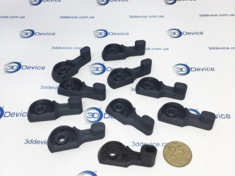 A collection of 3D-printed carbon parts, featuring intricate designs and a 25-kopeck coin for scale. These components are made with 3DDevice technology.