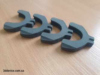 A set of four SLS 3D-printed parts with a characteristic grainy texture from 3DDevice.