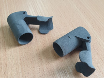Two gray SLS 3D-printed parts with a matte finish from 3DDevice.
