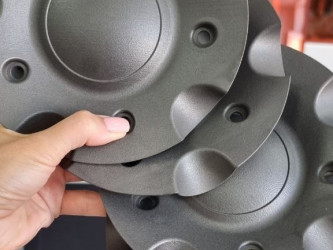 SLS 3D printed wheel center caps by 3DDevice for a car.