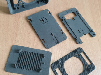 SLS 3D printed case parts by 3DDevice for an electronic device.